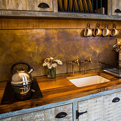 Rustic Shepherds Hut Kitchen with Brass Splashback